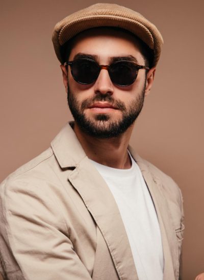 portrait-man-wearing-beige-jacket-cap-sunglasses-isolated-background.jpg